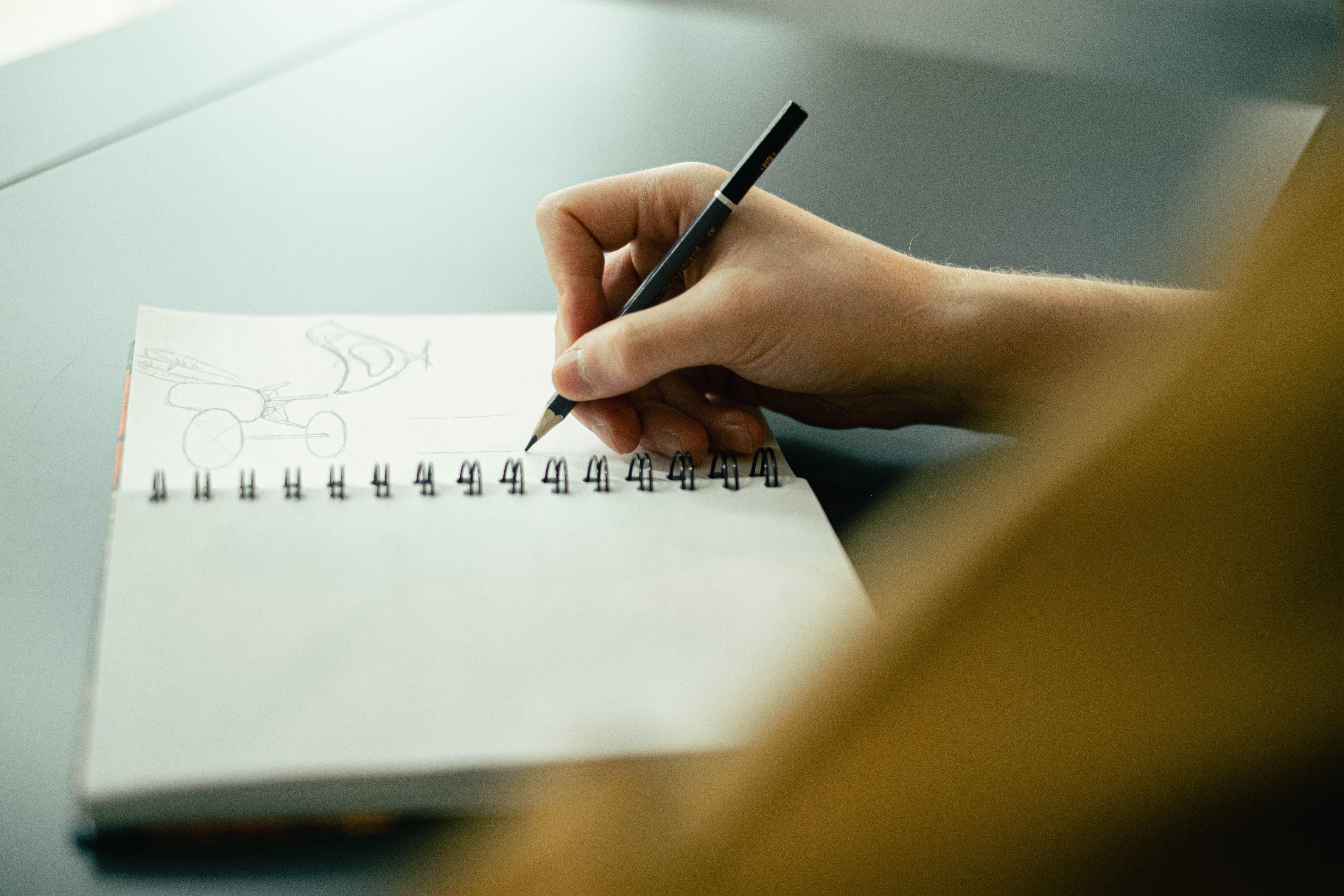 Logo design sketches and brand identity planning in a creative notebook
